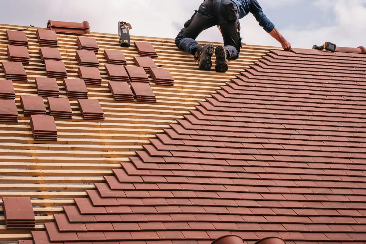 Close-up of impact-resistant Class 4 roofing shingles being installed on a residential roof