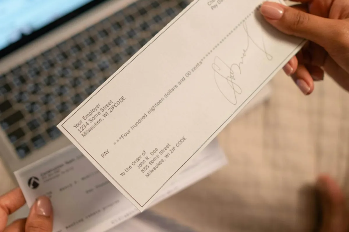 Homeowner receiving insurance check payment for roof replacement with contractor paperwork